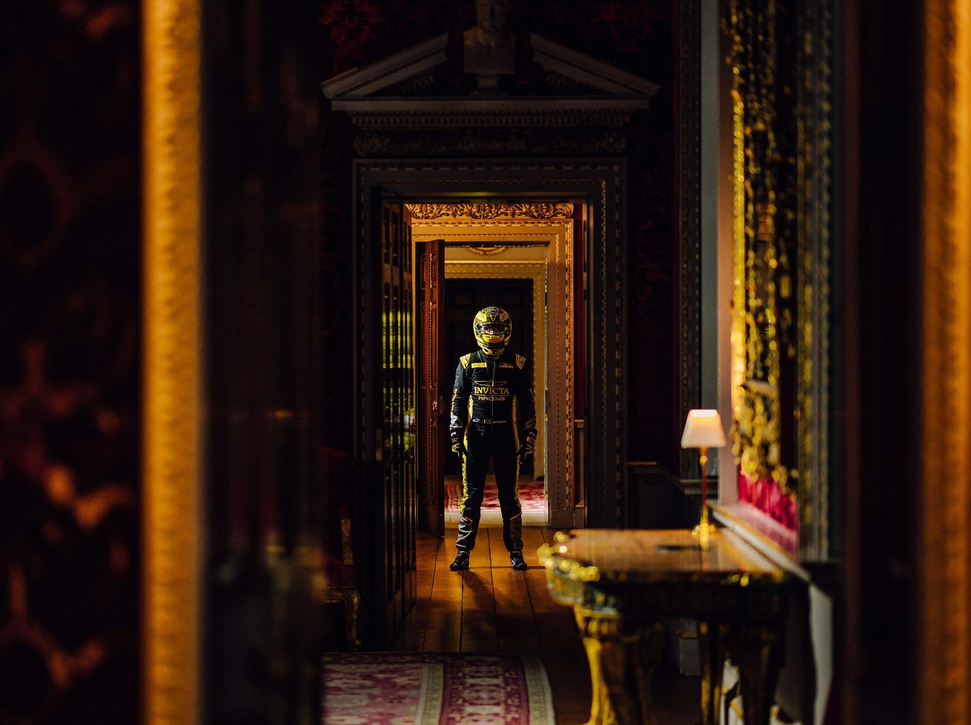Invicta Racing driver stands in the hallway of Holkham Hall castle