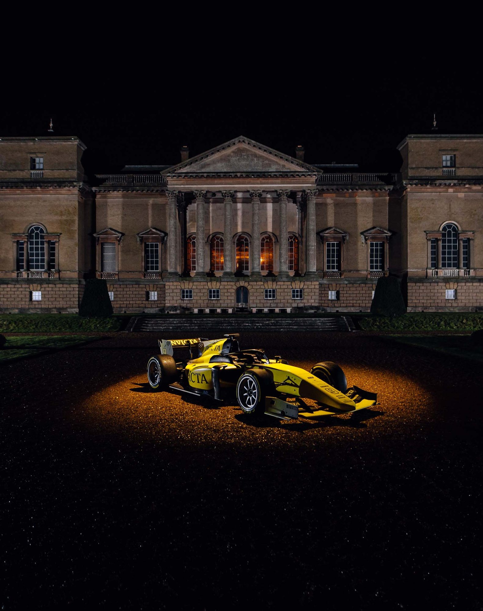 Invicta Racing car is outside in spotlight for Holkham Hall
